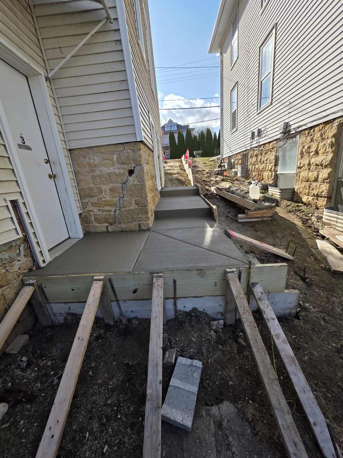 The same side entry with a new concrete landing poured inside wood forms